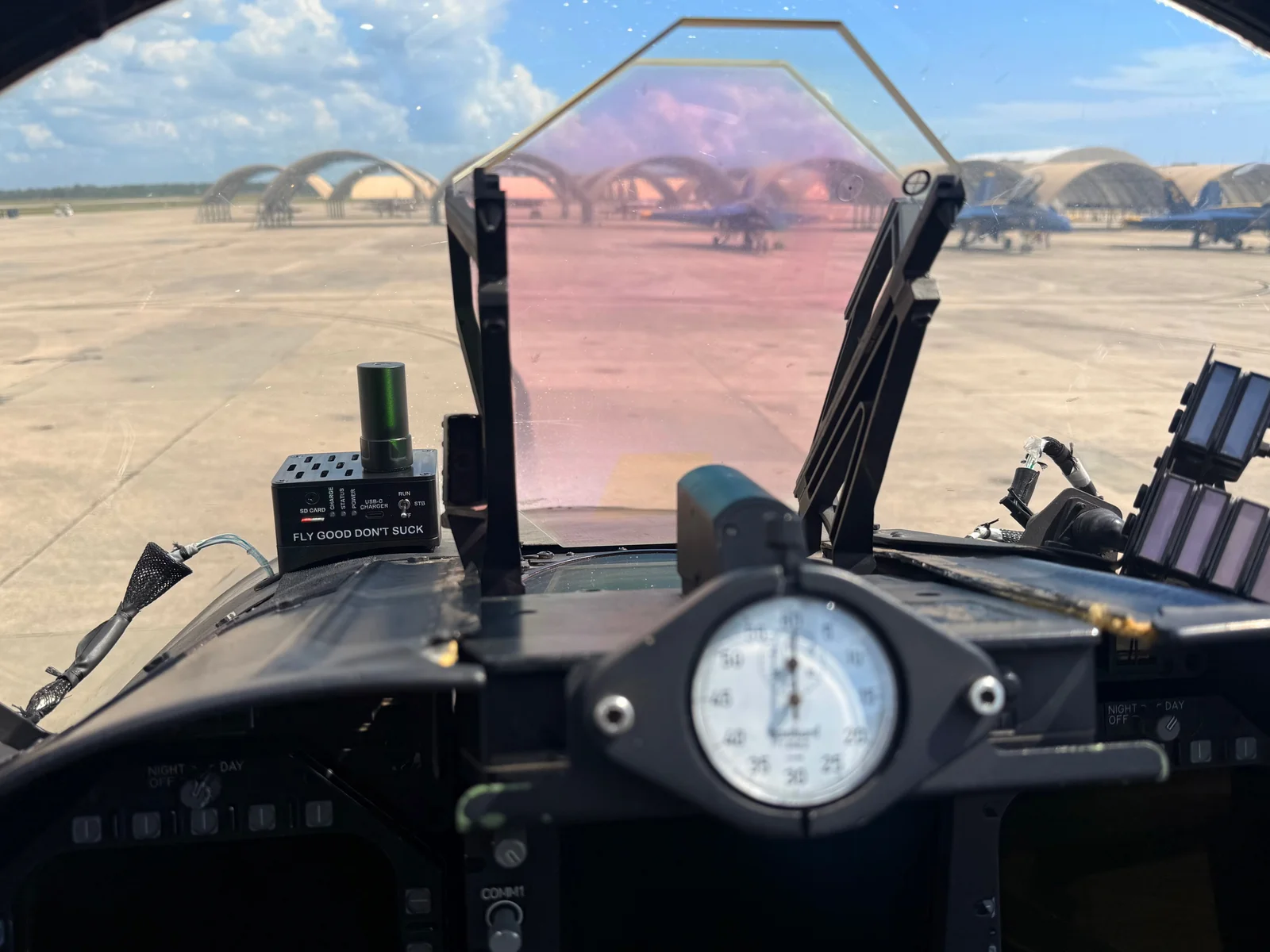 Prototype flight data logger mounted beside the head-up display in a Blue Angels cockpit